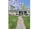 Charming single-story home with a covered front porch and well-manicured lawn with mature trees at 3101 Danbury Rd, Indianapolis, IN 46222