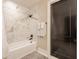 Bathroom with marble shower, white tub, and black hardware at 3549 W 131St St, Carmel, IN 46032