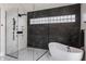 Modern bathroom featuring a soaking tub, walk-in shower, and sleek black and white marble tile at 3549 W 131St St, Carmel, IN 46032