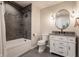Neutral bathroom with white vanity, granite countertop, decorative mirror and tiled shower at 3549 W 131St St, Carmel, IN 46032