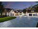 Stunning home exterior featuring a circular driveway and three-car garage with modern black-and-white Tudor style at 3549 W 131St St, Carmel, IN 46032