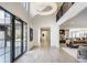 Bright foyer with soaring ceilings, hardwood floors, and grand chandelier, leading into open-concept living space at 3549 W 131St St, Carmel, IN 46032
