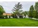 Charming home with a lush green lawn and mature trees creating a serene and inviting curb appeal at 3549 W 131St St, Carmel, IN 46032