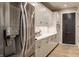 Bright kitchen featuring stainless steel refrigerator and white cabinets with quartz countertop and undercabinet lighting at 3549 W 131St St, Carmel, IN 46032