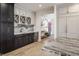 Stylish wet bar area in kitchen featuring custom dark cabinets, open shelving, and marble countertops at 3549 W 131St St, Carmel, IN 46032