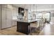 Bright open-concept kitchen featuring a large island with seating and a view of the dining room at 3549 W 131St St, Carmel, IN 46032