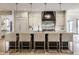Contemporary kitchen featuring a dark island with seating and gray cabinets with marble backsplash at 3549 W 131St St, Carmel, IN 46032