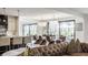 Bright open-concept living room featuring modern furniture, a kitchen island, and outdoor views at 3549 W 131St St, Carmel, IN 46032