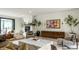 Contemporary living room with fireplace, modern art, and hardwood floors creating a sophisticated aesthetic at 3549 W 131St St, Carmel, IN 46032