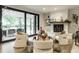 Bright living room featuring a stone fireplace, modern furniture, and a sliding glass door to the outside at 3549 W 131St St, Carmel, IN 46032