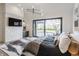 Bright main bedroom featuring a modern light fixture, brick accent wall, and sliding doors to the backyard at 3549 W 131St St, Carmel, IN 46032