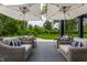 Relaxing patio area featuring comfortable seating and stylish umbrellas with backyard views at 3549 W 131St St, Carmel, IN 46032