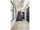 Modern foyer featuring floating stairs, light wood floors, and a dramatic black sliding barn door at 3549 W 131St St, Carmel, IN 46032
