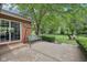 Outdoor patio with a porch swing, manicured lawn, mature trees, and serene landscaping for outdoor enjoyment at 3571 S Cedar Creek Ln, New Palestine, IN 46163