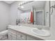 Bright bathroom with a double sink vanity, large mirror, and a shower with a floral curtain at 3571 S Cedar Creek Ln, New Palestine, IN 46163