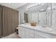 Bathroom with a double sink vanity, large mirror, and a shower with a waffle weave curtain at 3571 S Cedar Creek Ln, New Palestine, IN 46163