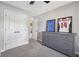 Bedroom with gray walls, carpet, a dresser, closet, and doorway leading to the hallway at 3571 S Cedar Creek Ln, New Palestine, IN 46163