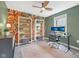 Bedroom featuring a desk, floral wallpaper, bookshelves, ceiling fan, and a window with blinds at 3571 S Cedar Creek Ln, New Palestine, IN 46163
