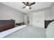 Well lit bedroom featuring a bed, bedside table, dresser, closet, ceiling fan, and doorway at 3571 S Cedar Creek Ln, New Palestine, IN 46163
