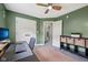 Bedroom featuring green walls, closet, and doorway, shelves and a desk with computer at 3571 S Cedar Creek Ln, New Palestine, IN 46163