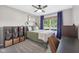 Bedroom featuring a bed, nightstand, desk, a ceiling fan, shelving, and a window with blinds at 3571 S Cedar Creek Ln, New Palestine, IN 46163