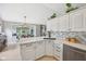 Bright, updated kitchen with white cabinets, granite countertops, and open concept view at 3571 S Cedar Creek Ln, New Palestine, IN 46163