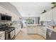 Spacious kitchen with white cabinetry, stainless steel appliances, and open layout at 3571 S Cedar Creek Ln, New Palestine, IN 46163