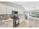 Well-appointed kitchen featuring white cabinets, stainless steel appliances, and ample counter space at 3571 S Cedar Creek Ln, New Palestine, IN 46163