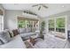 Bright living room with large windows, sliding glass door, and comfortable seating at 3571 S Cedar Creek Ln, New Palestine, IN 46163