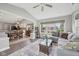 Open-concept living room with hardwood floors, large windows, and comfortable seating at 3571 S Cedar Creek Ln, New Palestine, IN 46163