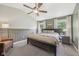 This main bedroom boasts a ceiling fan, large bed, nightstands, and windows with sheer curtains at 3571 S Cedar Creek Ln, New Palestine, IN 46163