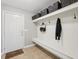 Functional mudroom features a built-in bench, coat hooks, overhead storage, and access to the outdoors at 3571 S Cedar Creek Ln, New Palestine, IN 46163
