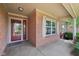 Covered porch featuring brick columns and a decorative front door at 3571 S Cedar Creek Ln, New Palestine, IN 46163