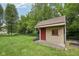 A simple shed in a well-maintained yard shows extra storage on a lush lawn at 3571 S Cedar Creek Ln, New Palestine, IN 46163