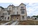 Newly constructed two-story townhome showcasing modern farmhouse style with neutral siding and black trim at 4141 Barrel Ln, Westfield, IN 46062