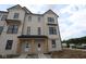 A modern two-story townhome boasts a stylish exterior with a combination of siding and brick accents at 4141 Barrel Ln, Westfield, IN 46062