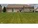 A spacious backyard with a shed, a covered outdoor living area with sliding glass door and a grill at 4353 W Parkway Ct, New Palestine, IN 46163