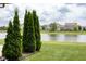 Peaceful backyard with a serene pond view and lush green landscaping at 4353 W Parkway Ct, New Palestine, IN 46163