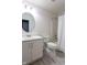 Well-lit bathroom with a single sink vanity, toilet, framed mirror, and a tub-shower combo at 4353 W Parkway Ct, New Palestine, IN 46163