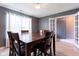Formal dining room with a large wooden table, chairs, and natural light from the window at 4353 W Parkway Ct, New Palestine, IN 46163