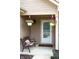 Inviting front porch featuring hanging flower baskets and a cozy bench for relaxing outdoors at 4353 W Parkway Ct, New Palestine, IN 46163