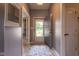 Welcoming hallway with light gray walls and flooring, leading into the home's interior spaces at 4353 W Parkway Ct, New Palestine, IN 46163