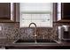 Modern kitchen sink with a sleek faucet and a window providing natural light in the area at 4353 W Parkway Ct, New Palestine, IN 46163