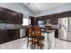 Modern kitchen with dark cabinetry, stainless steel appliances, and a stylish backsplash design at 4353 W Parkway Ct, New Palestine, IN 46163