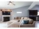 Comfortable living room featuring a fireplace, large TV, and an oversized sectional sofa at 4353 W Parkway Ct, New Palestine, IN 46163