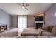 Spacious living room with a fireplace, mounted TV, comfortable seating, and a ceiling fan at 4353 W Parkway Ct, New Palestine, IN 46163