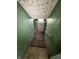 View of basement stairs leading to a door, with green painted walls at 4709 E New York St, Indianapolis, IN 46201