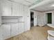 Kitchen with a white cabinets and a view into the dining and living area at 4709 E New York St, Indianapolis, IN 46201