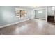 Large living room showcasing wood floors, windows, and a staircase; ready for renovation at 4709 E New York St, Indianapolis, IN 46201