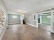 Spacious living room with natural light and original wood floors; ready to be renovated at 4709 E New York St, Indianapolis, IN 46201